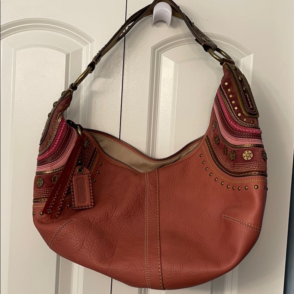 Pink leather embellished Coach satchel.